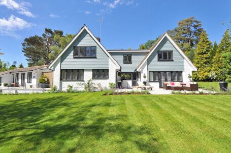 Lawn Mowing - White and Gray Wooden House Near Grass Field and Trees